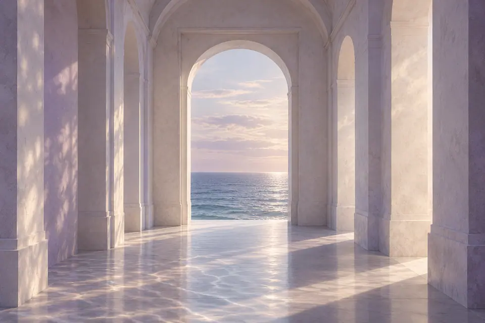 A pale arched hall opens onto the sea, with reflected light across its floor.